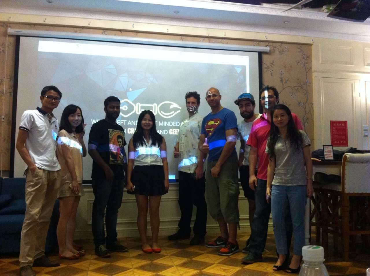 Designers gathered beside a Madrasters presentation screen