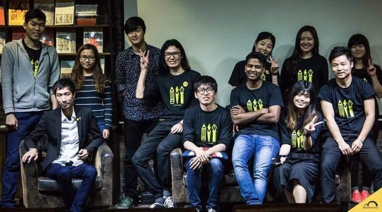 A group wearing Madrasters community shirts