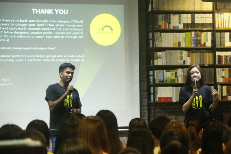 Two speakers addressing an audience