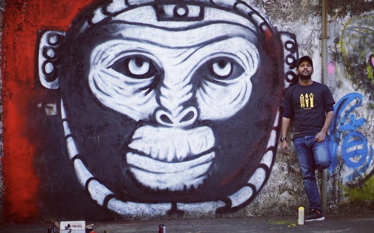 Saravana beside artwork during a weekend graffiti community session